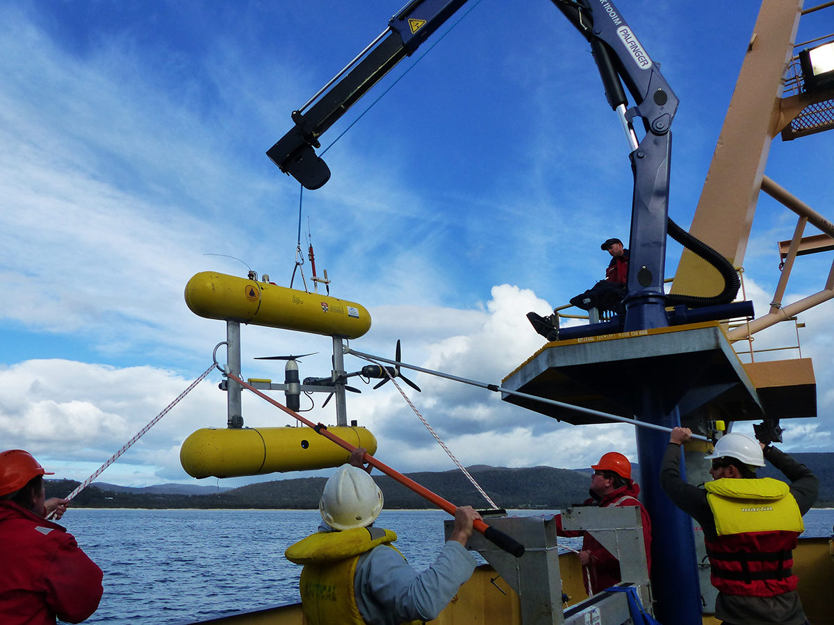 An autonomous underwater vehicle being deployed from a  vessel