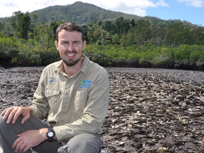 Dr Ian McLeod From James Cook University sits near a leaf oyster reef in Hinchinbrook Channel.