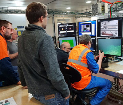 scientists watch the live feed of the seafloor