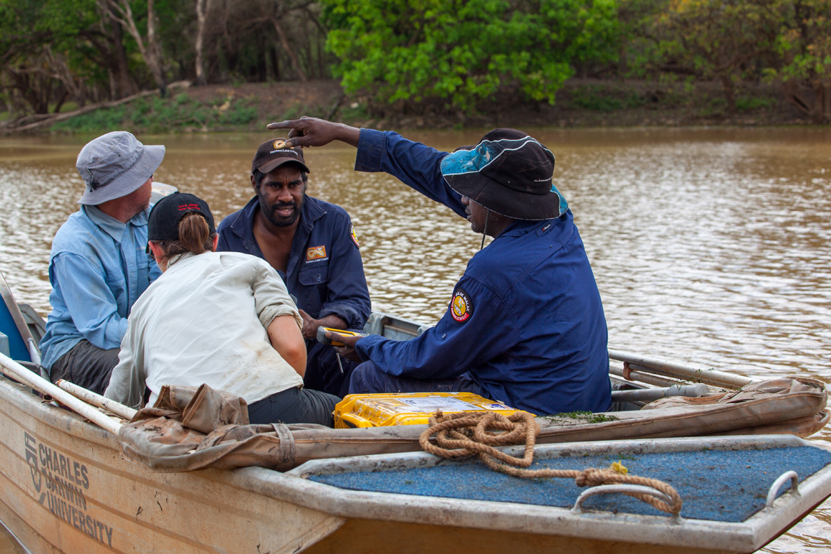 Scientists and Indigenous rangers in a boat on the Daly River, NT