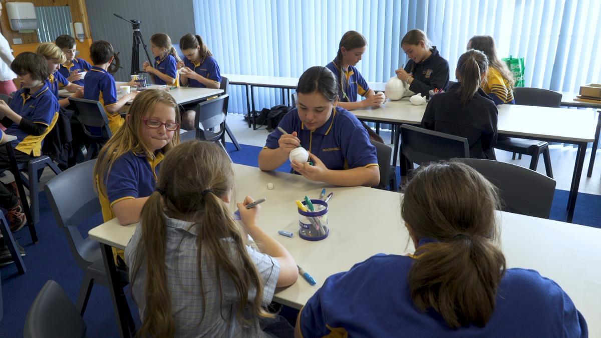 Woodbridge primary students paint styrofoam cups