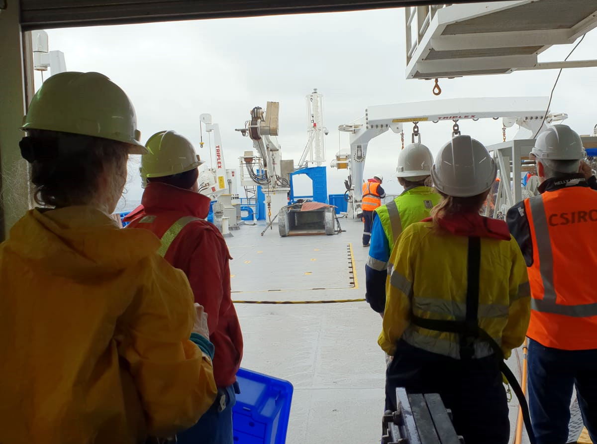 Scientists wait on deck for the beam trawl